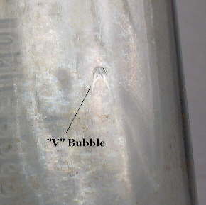 "V" bubble in a 1920's era machine-made bottle; click to enlarge.