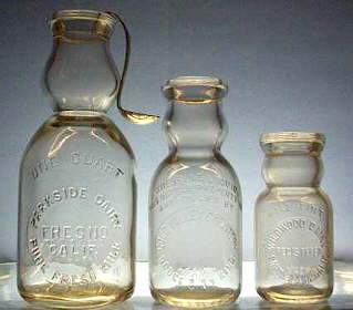 Cream top milk bottles; click to enlarge.